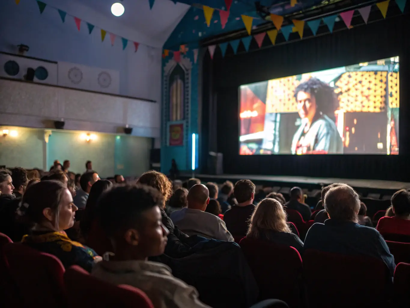 An image of a cinema screen showing an Italian film with an engaged audience, capturing the essence of a DOLCE CINEMA film screening event.